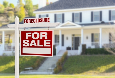 Foreclosure sign in front of a large house. | James J. Quail & Associates, P.C.